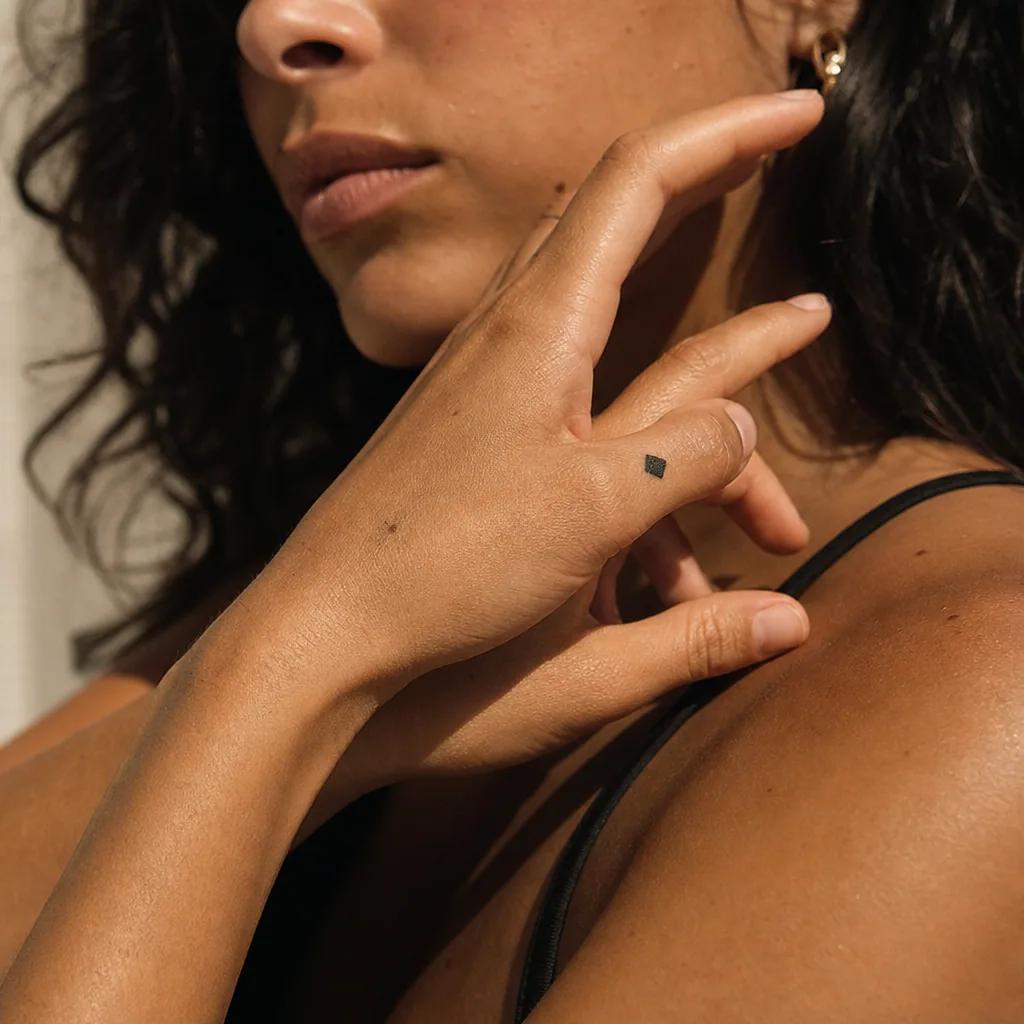 small tattoo blackwork solid square, realistic photo on skin